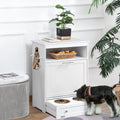 White pet feeder station cabinet with dog eating from pull out bowl drawer