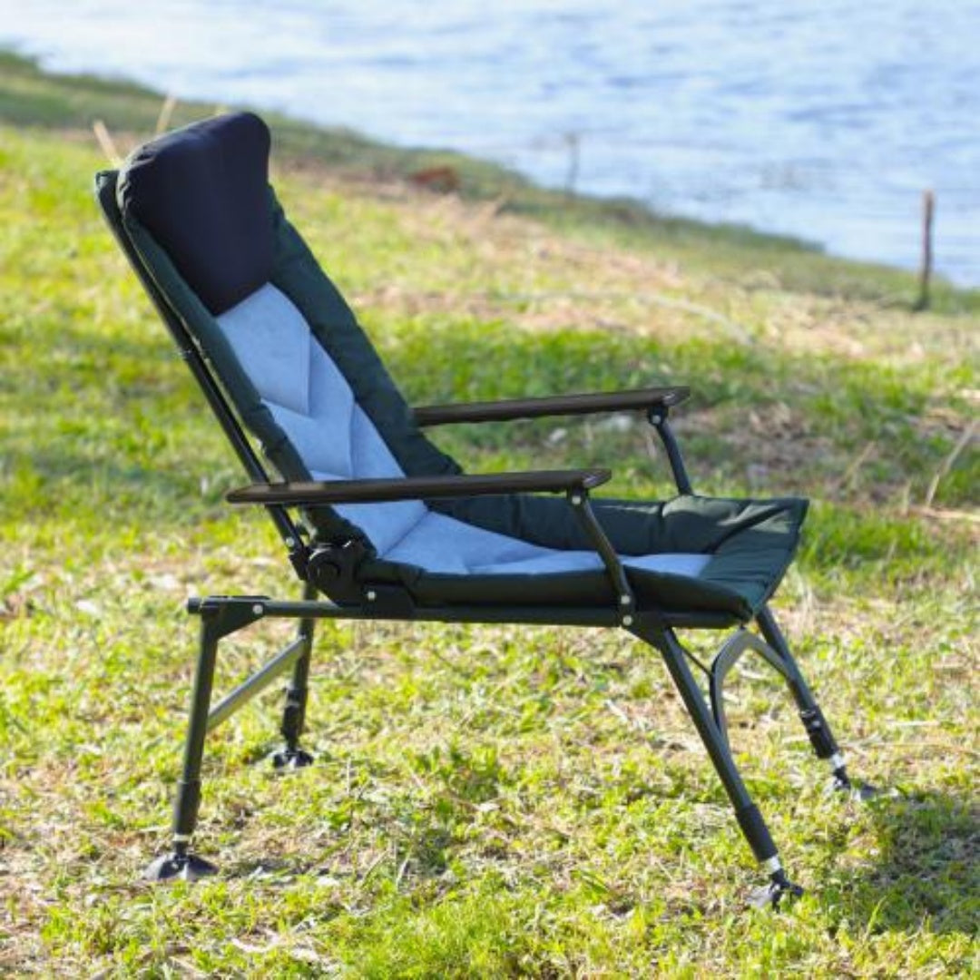 Folding camping recliner chair at campsite with table view two